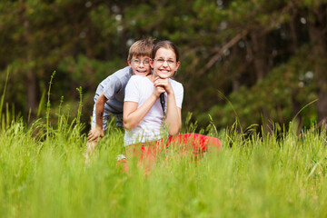 Fototapeta premium Boy and girl in a grass field