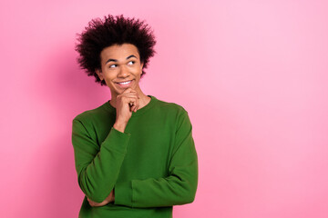 Photo of happy positive clever guy thinking look empty space isolated pastel color background