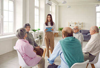 Senior people having a therapy session at the retirement home. Group of old, retired men and women...