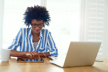 Woman, technology and research at desk for blog, social media and email in apartment. African female journalist, networking and working from home for typing, newspaper article and online magazine