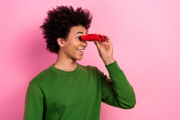 Photo of astonished guy look binoculars empty space impressed isolated pastel color background
