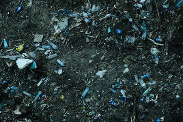 soil polluted with garbage and plastic waste