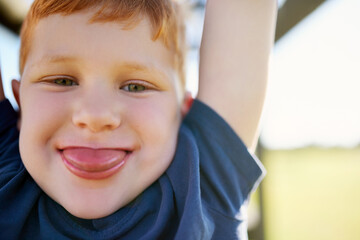 Portrait, boy and smile in park, monkey bars and happy with playing, outdoor and adventure, Child,...