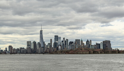 downtown manhattan skyline on a cloudy day (world trade center) one skyscraper tall buildings (financial center) hudson river, liberty state park view new york city nyc metropolis cityscape