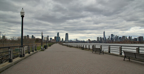 view of walking biking pedestrian cycling path trail in liberty state park with view of downtown...