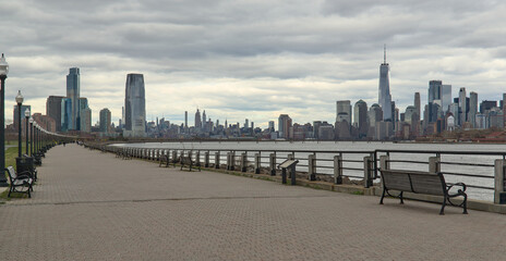 view of walking biking pedestrian cycling path trail in liberty state park with view of downtown...
