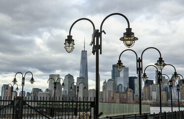 view of downtown manhattan new york city skyline with lanterns on pier (dock at libery state park...