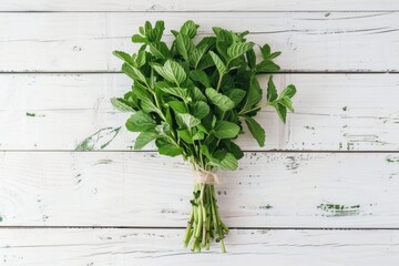 A bunch of spinach on a white wooden table, ideal for healthy food concept