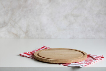 kitchen background, mockup. an empty cutting board and a checkered red towel on a table. copy space.