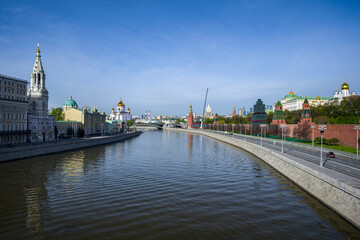 VIEW FROM THE BOLSHOY MOSKVORETSKY BRIDGE TO THE MOSCOW RIVER, THE EMBANKMENT OF THE MOSCOW KREMLIN, THE CATHEDRAL OF CHRIST THE SAVIOR ON A SUNNY SPRING MORNING