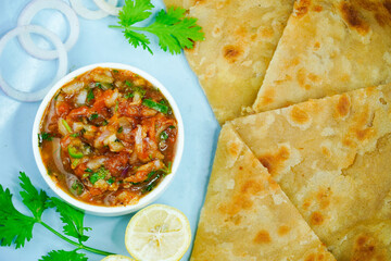 Classic homemade tomato sauce. Tomato chatni. Tomato sauce with onion, coriander and spices with paratha