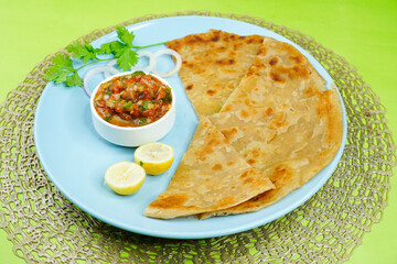 Classic homemade tomato sauce. Tomato chatni. Tomato sauce with onion, coriander and spices with paratha