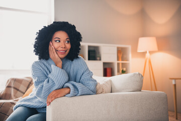 Portrait of nice lady sit sofa brainstorming wear blue sweater modern interior flat indoors