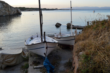 Two boats docked at a beach dock