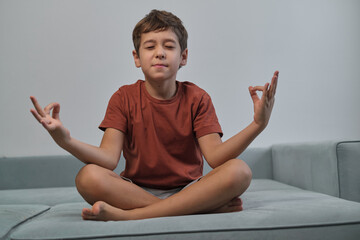 Boy in a lotus pose, hands in mudra, eyes closed. Reflects the growing importance of teaching...