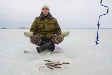 A man enjoys winter fishing.