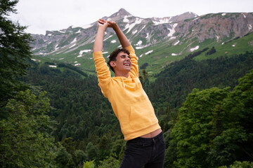 A young attractive student is resting in the mountains.