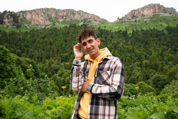 A young attractive student is resting in the mountains.