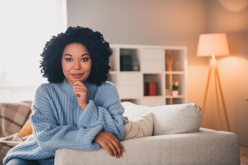 Portrait of nice lady sit sofa think wear blue sweater modern interior flat indoors