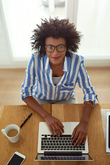 Portrait, woman and top view with laptop, working and home with coffee, remote work and smile....