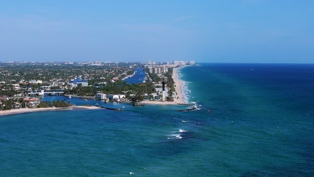Aerial view of Pompano Beach showcasing beautiful contrast between deep blue ocean and white sandy beach with greenery of cityscape. Concept of landscapes