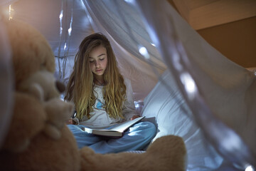 Night, girl and blanket fort for reading book, learning or education for childhood development....