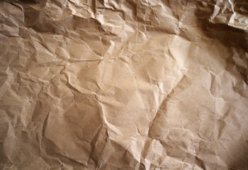 Craft crumpled paper, cardboard background. Brown kraft sheet texture, torn antique page, wallpaper...