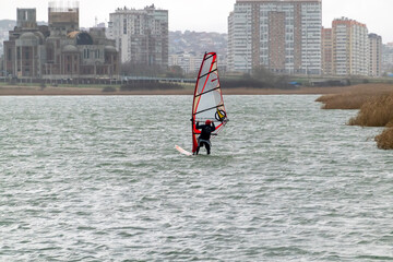 A kite surfer rides and jumps the waves the black sea