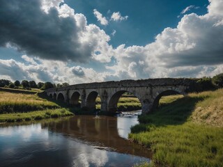 A bridge spans a river with a cloudy sky in the background
