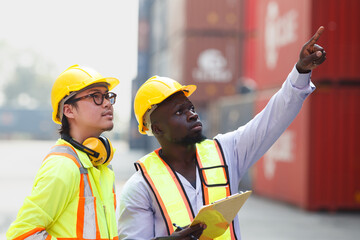 Container yard workers examine the container cargo.
