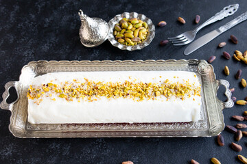 Traditional Turkish Maras Cut Ice Cream,on a silver tray with cutlery and pistachios