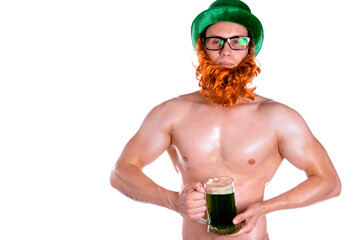 Young attractive guy posing in the studio with green beer. St.Patrick 's Day.