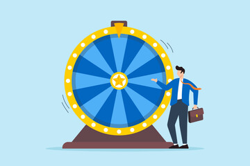 Excited businessman look at spinning fortune wheel waiting for luck. Concept of life depends on luck, randomness, chance, and opportunity. Concept of gambling activities where outcomes are uncertain