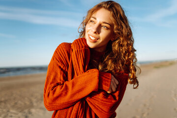 Portrait of beautiful youngfemale on the sand at the beach. Fashion, beauty, lifestyle concept.