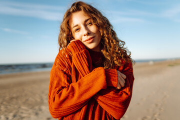 Portrait of beautiful youngfemale on the sand at the beach. Fashion, beauty, lifestyle concept.