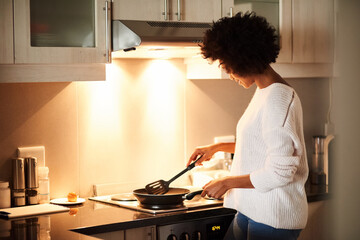 Black woman, pan and cooking on stove in home, frying and meal preparation in kitchen. Female...