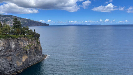 Fototapeta premium A stunning ocean view from a cliffside on Madeira Island, with clear blue skies and calm waters