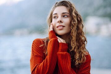 Portrait of a beautiful curly woman outdoor in cold weather. Concept of lifestyle, fashion, travel.