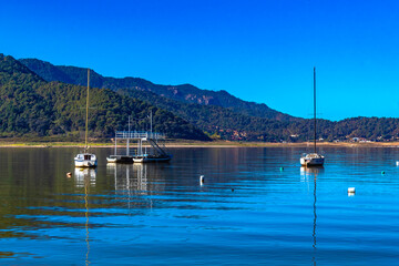 Boats and motorboats on sunny lake, in Valle de Bravo state of Mexico 