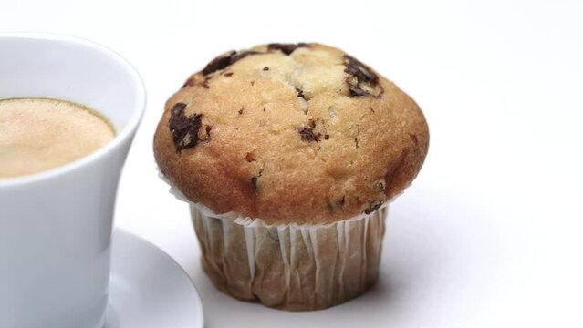 Muffin twist with coffee. Camera rotates around muffin cake and espresso coffee cup. 4K Stop motion animation.