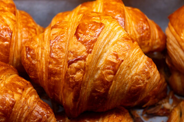 Breakfast in France, fresh baked butter croissants in artisanal bakery in Paris, France