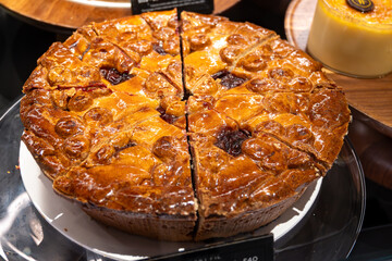 Classical closed apple pie with apples, raisins and cinnamon