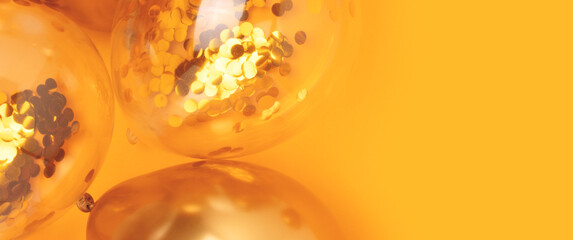 Banner with gold colored balloons on a yellow background. Selective focus.