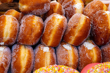 Stuffed Berlin balls with cream or fruit jam for sale on food market