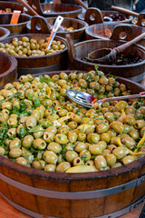 Pickled and marinated olives, artichokes, vegetables on farmers market, tasty tapas
