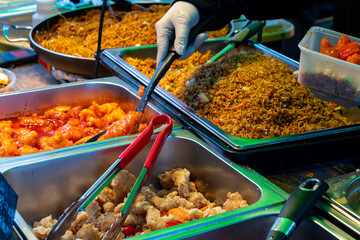 Local asian food, singapore noodle and rice dish with vegetables, fried shrimps and chicken meat