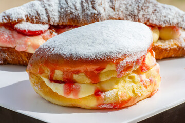 Dutch cuisine, fresh baked strawberry cake and croissant with cream and fresh fruits
