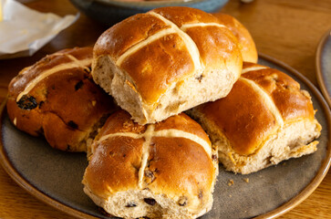 Traditional British Easter food, fresh baked cross buns with raisins or apples