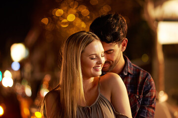 Couple, people and affection with smile in outdoor, together and support at night in London. Relationship, date and bonding for romance with sunset for care, relax and happiness as soulmate for love