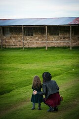 Mother and daughter People in a mountain sierra puno Peru landscape background